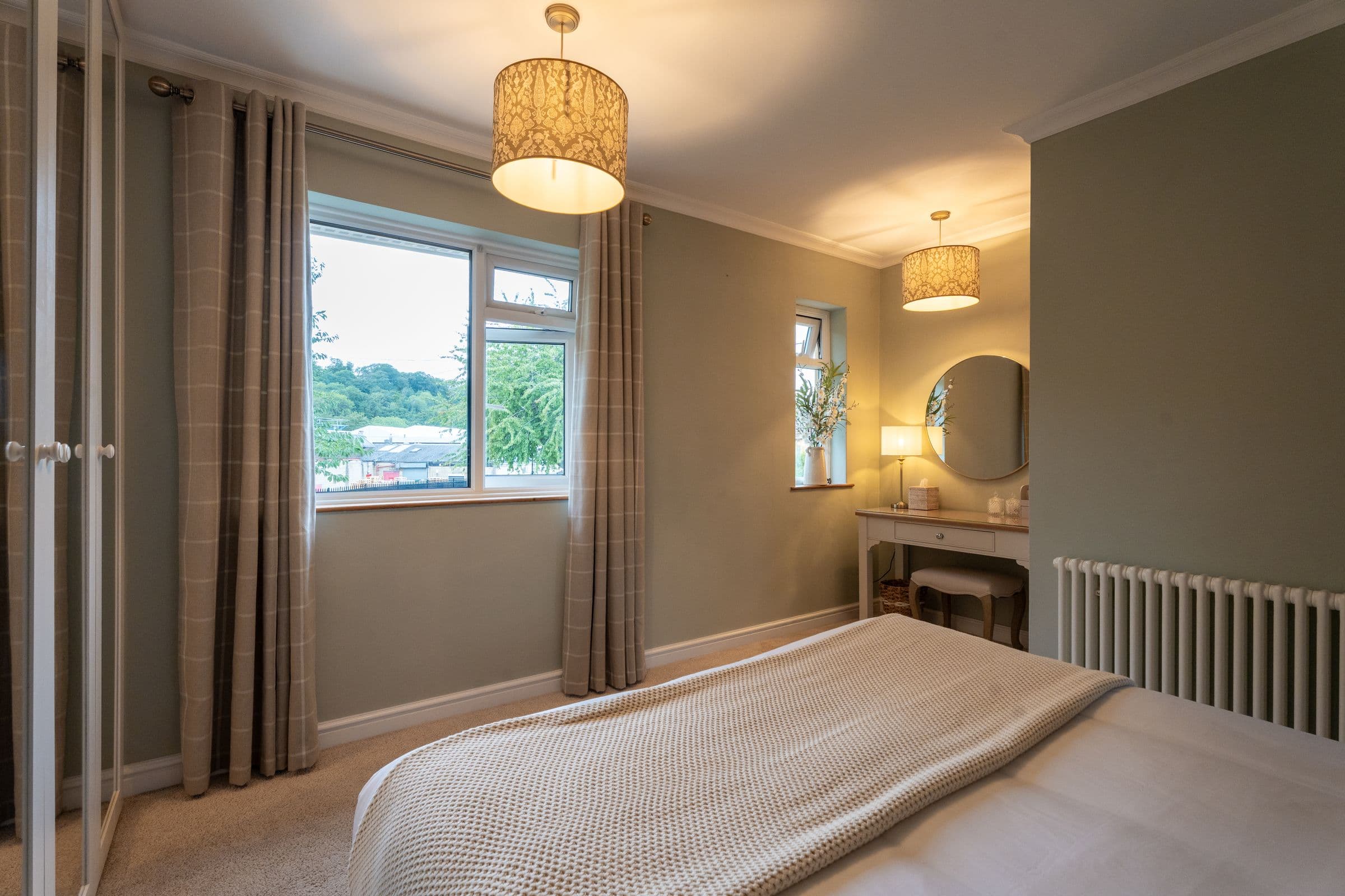 The main bedroom looking towards the window, with the curtains drawn back.