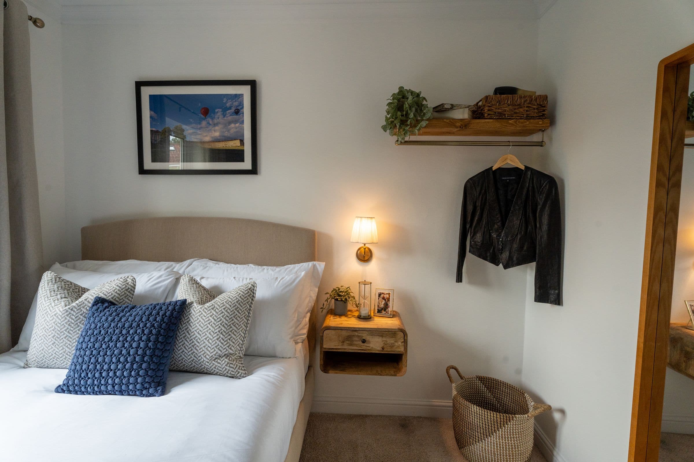 The shelf, basket and hanging rail beside the second bedroom's bed.