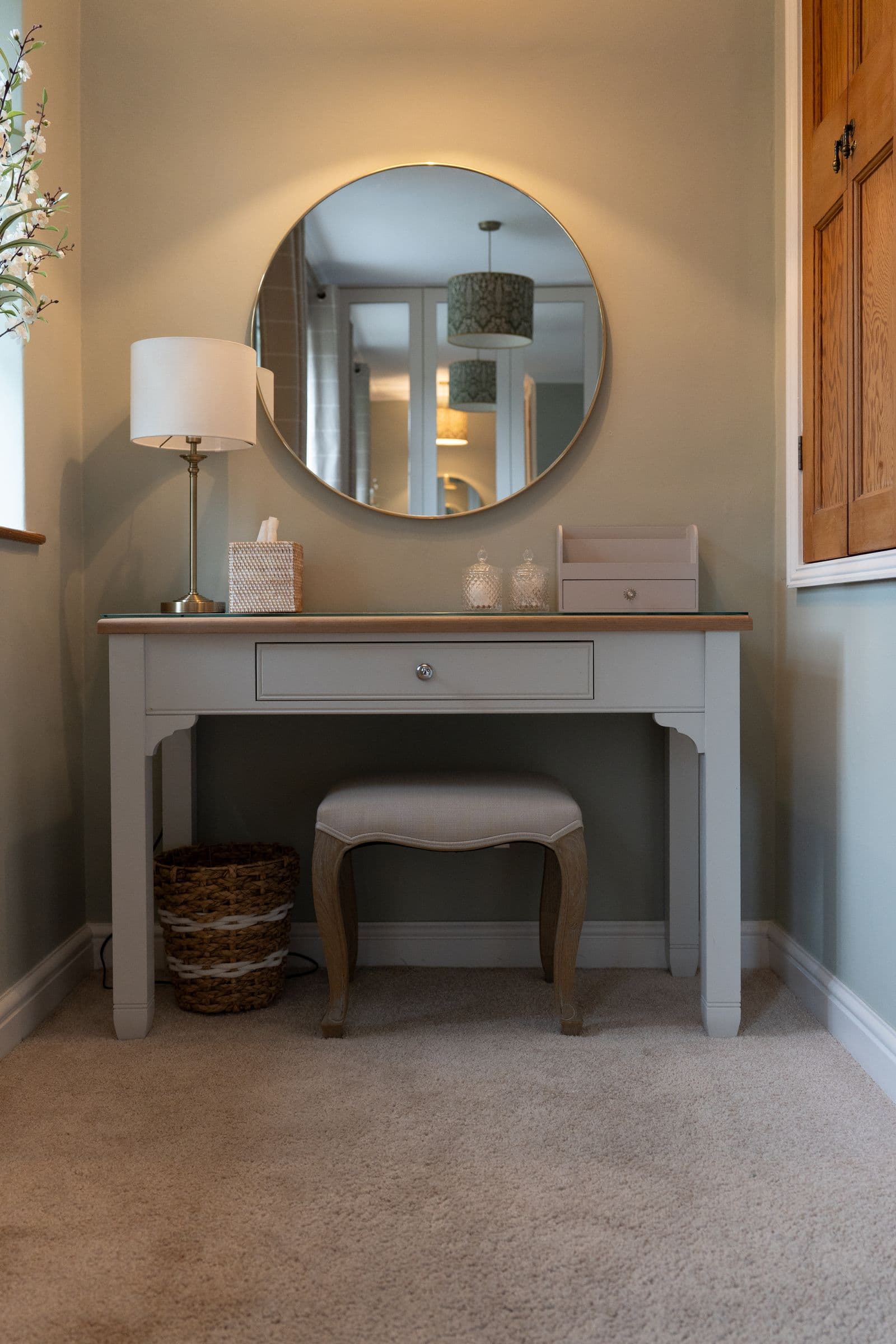 The dressing table, stool and round mirror in the main bedroom.