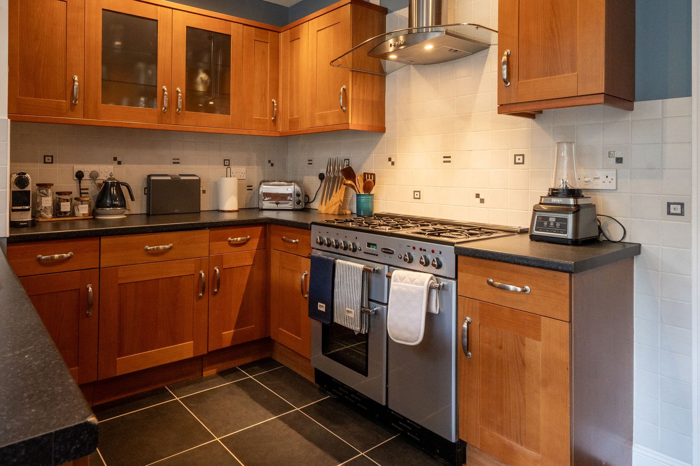 The Rangemaster range cooker with its five gas burners, set into the run of units.