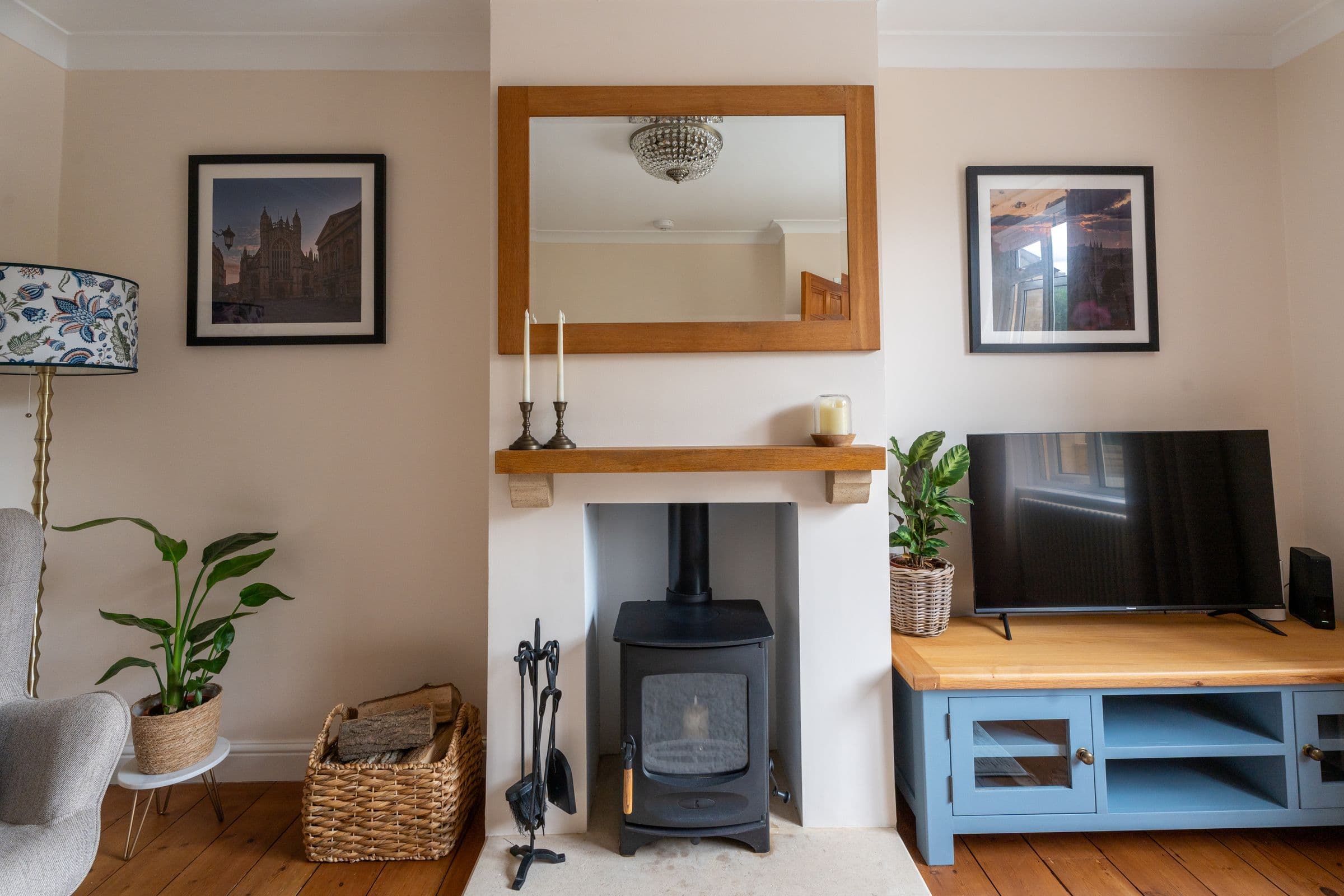 The wood burner set into the chimney breast, with candles on the mantel above.